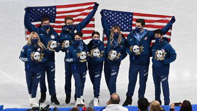 U.S. team members hold American flags