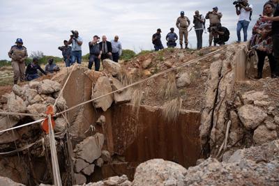 Rescuers try to free men trapped in South African gold mine with scores reported dead